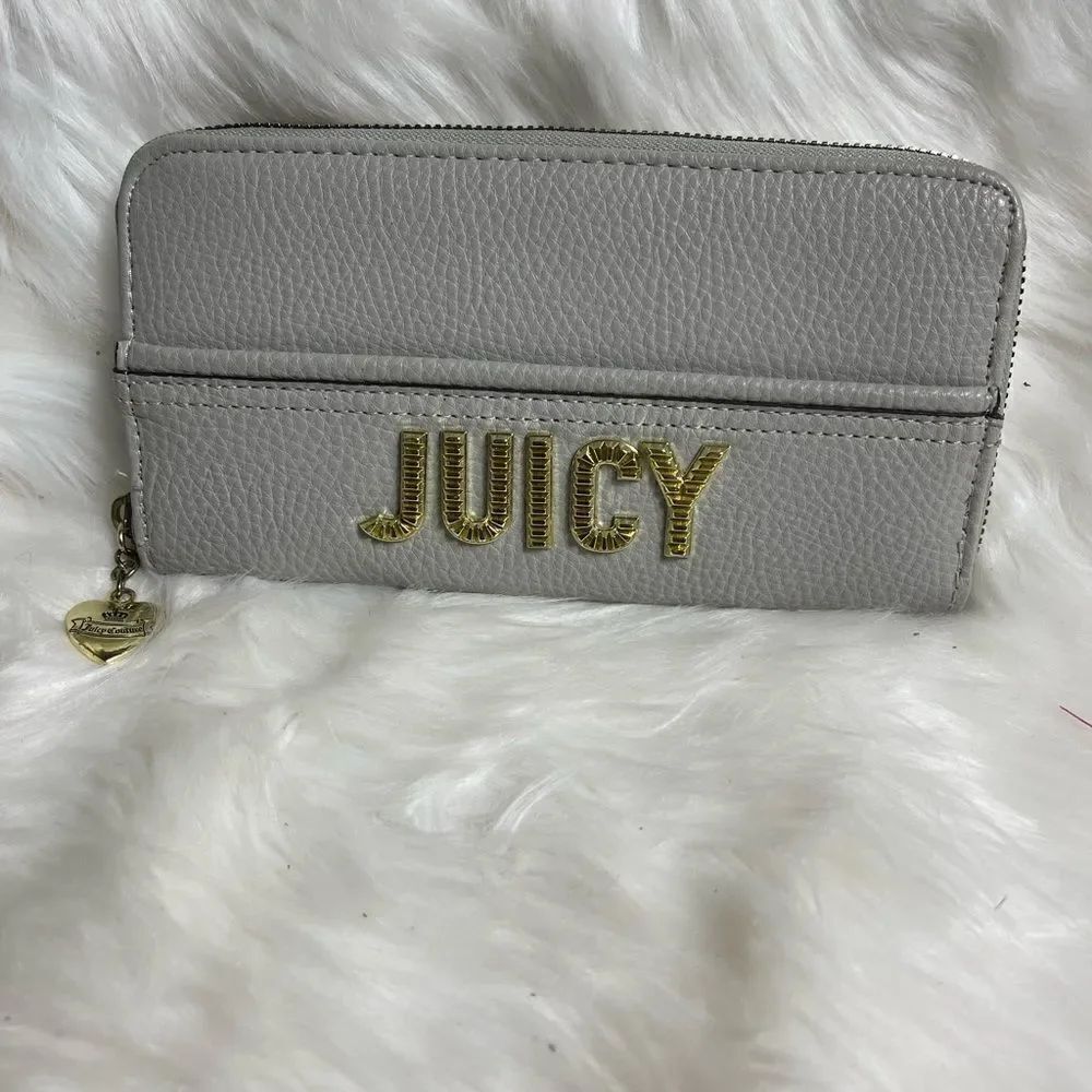 NWOT Juicy Couture gray zipper wallet with gold tone accents.